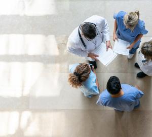Pictured: A circle of healthcare workers viewed from above