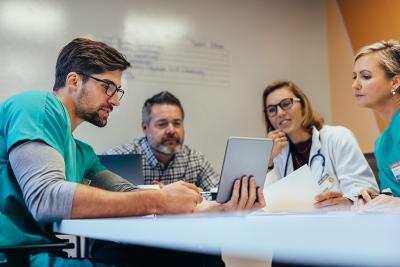 A four-person team looking at a notebook