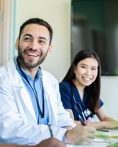 Doctors smiling at a meeting