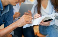 Students looking at textbook