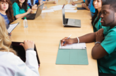 Healthcare professionals meeting around a large table