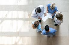 Pictured: A circle of healthcare workers viewed from above