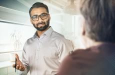 Photo of a professional speaking to a colleague