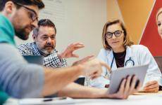 Photo of healthcare professionals looking at tablet