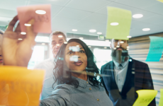 Photo of colleagues working with sticky notes