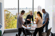 Photo of colleagues speaking around a table