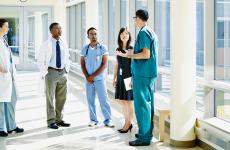 Healthcare professionals meeting in hospital hallway