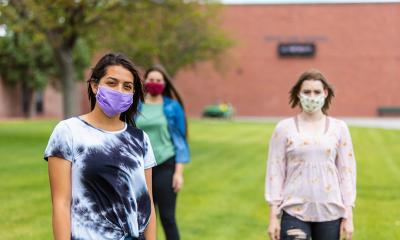 Three students wearing masks