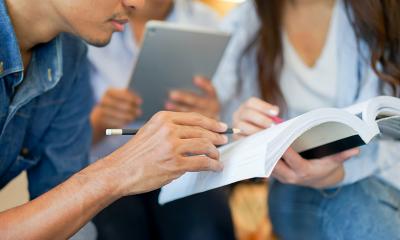 Students looking at textbook