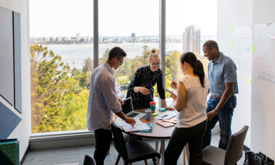 Photo of colleagues speaking around a table