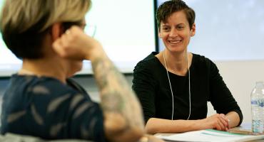 Trainer sitting with trainees