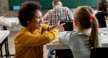 Teacher working with young student