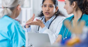 Clinicians speaking over laptop