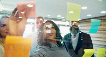 Photo of colleagues working with sticky notes