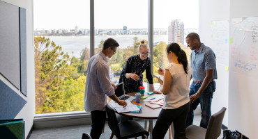 Photo of colleagues speaking around a table