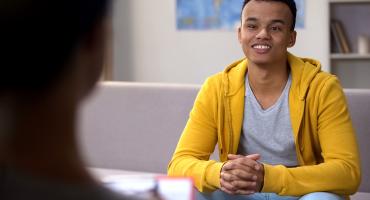 Photo of young man smiling at therapist