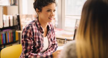 Photo of young person speaking to therapist