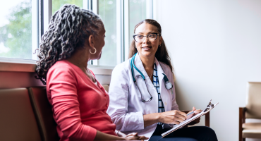 Health professional speaking to patient