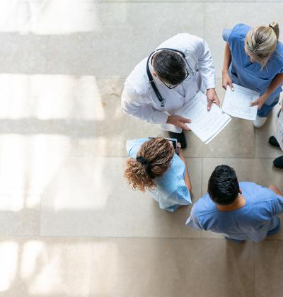 Pictured: A circle of healthcare workers viewed from above