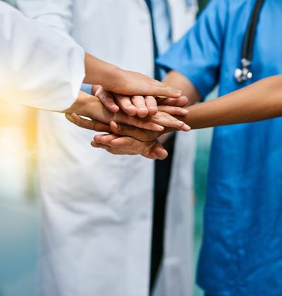 Healthcare professionals stacking hands