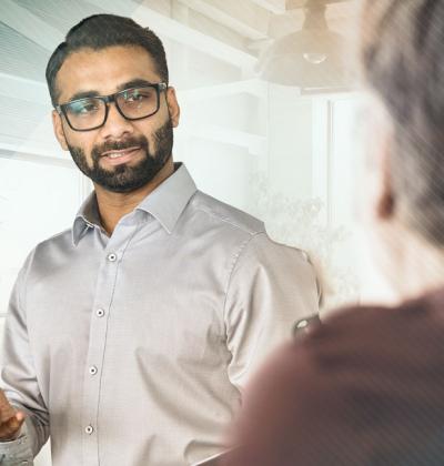 Photo of a professional speaking to a colleague