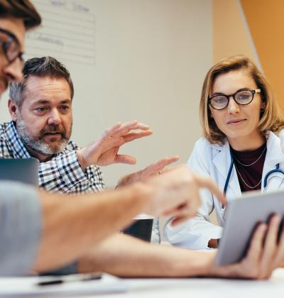 Photo of healthcare professionals looking at tablet