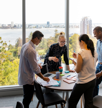 Photo of colleagues speaking around a table