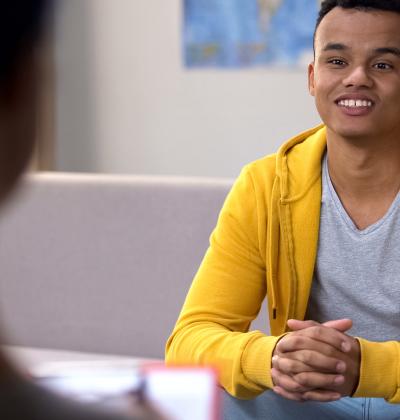 Photo of young man smiling at therapist