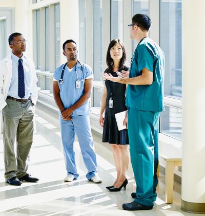 Healthcare professionals meeting in hospital hallway