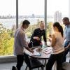 Photo of colleagues speaking around a table
