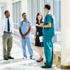 Healthcare professionals meeting in hospital hallway